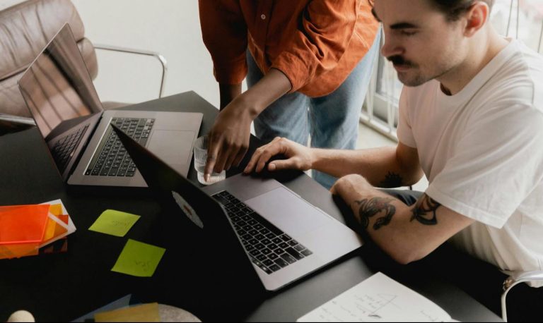 Two people looking at a computer